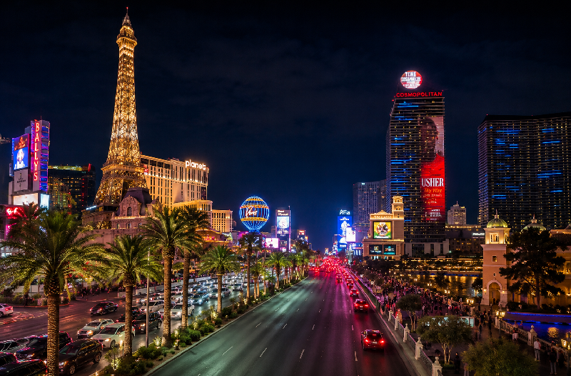 Las Vegas Strip at night with the Paris Las Vegas Eiffel Tower and the Cosmopolitan Hotel
